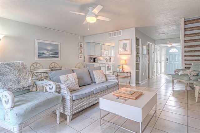 tiled living room featuring ceiling fan