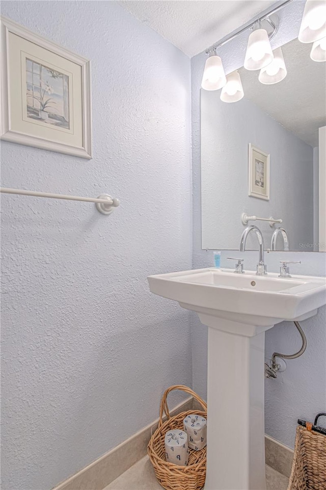 bathroom featuring sink and a textured ceiling