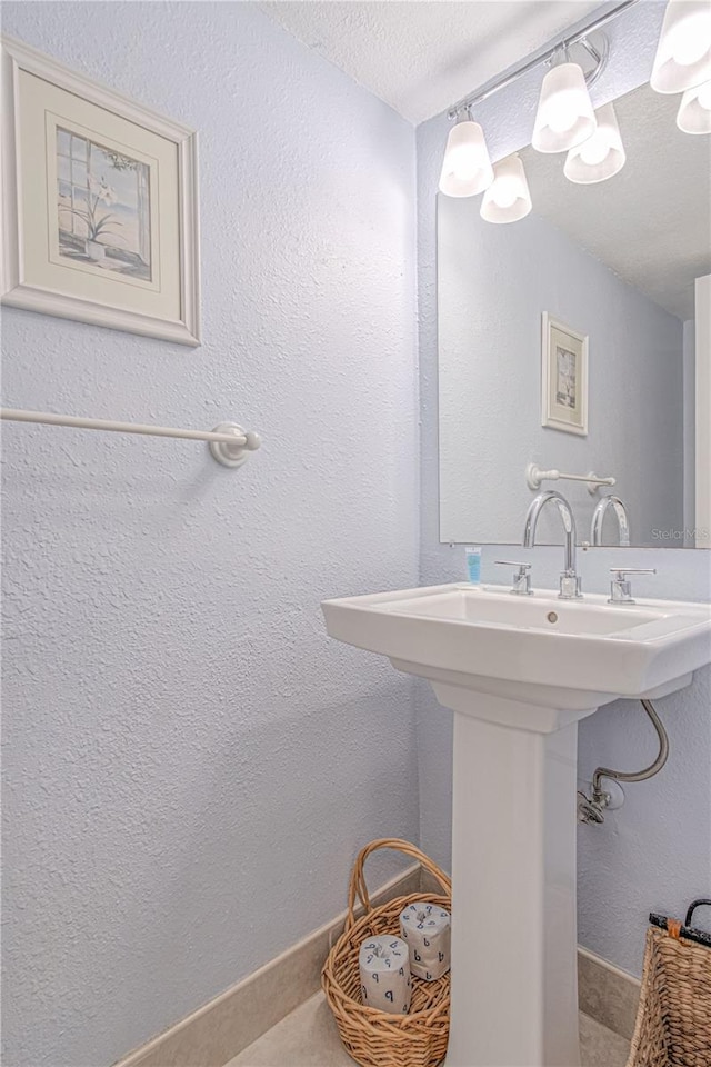 4017 Saxon Dr, New Smyrna Beach, FL 32169 - bathroom featuring a textured ceiling and a textured wall