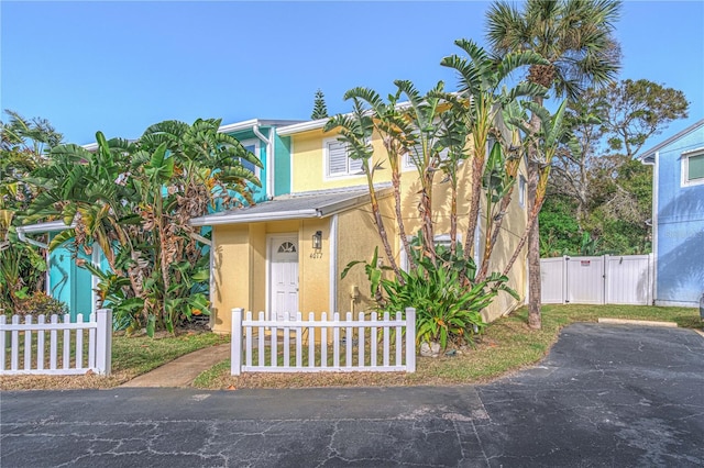 4017 Saxon Dr, New Smyrna Beach, FL 32169 - view of front of property featuring stucco siding and a gate