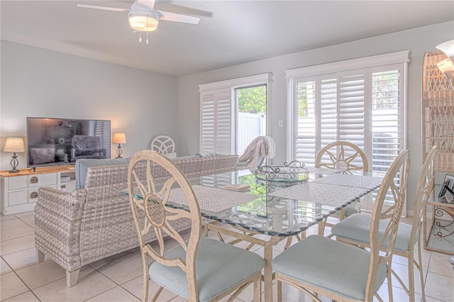 tiled dining room featuring ceiling fan