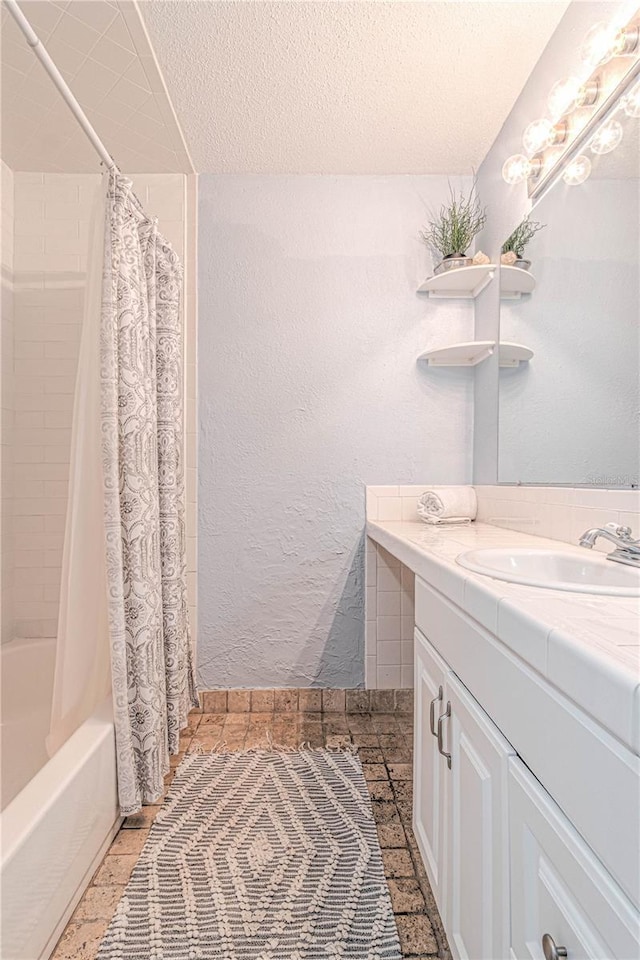 4017 Saxon Dr, New Smyrna Beach, FL 32169 - full bath with vanity, shower / bath combination with curtain, and a textured ceiling