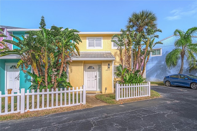 4017 Saxon Dr, New Smyrna Beach, FL 32169 - view of front of house with stucco siding, uncovered parking, and a metal roof