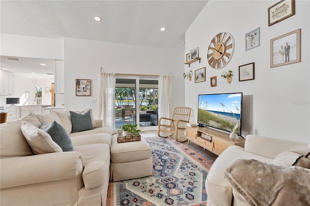 living room with a textured ceiling and sink