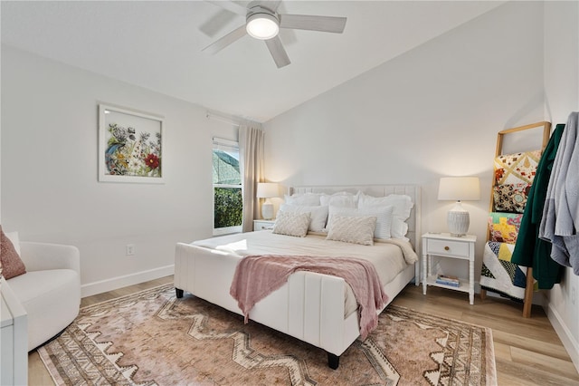 bedroom with hardwood / wood-style flooring, ceiling fan, and vaulted ceiling