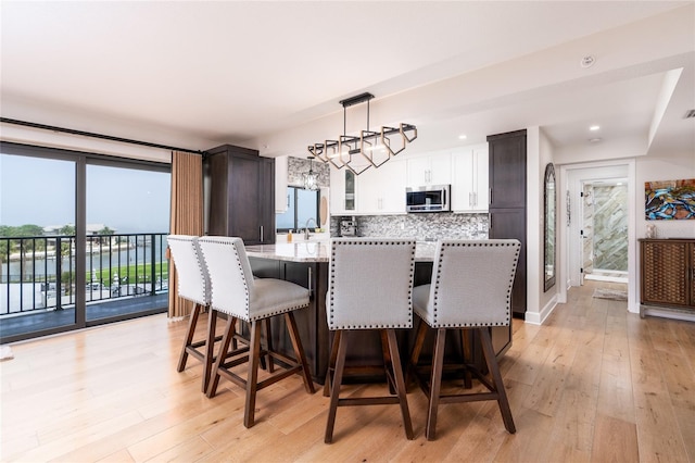 dining space featuring plenty of natural light and light wood-type flooring