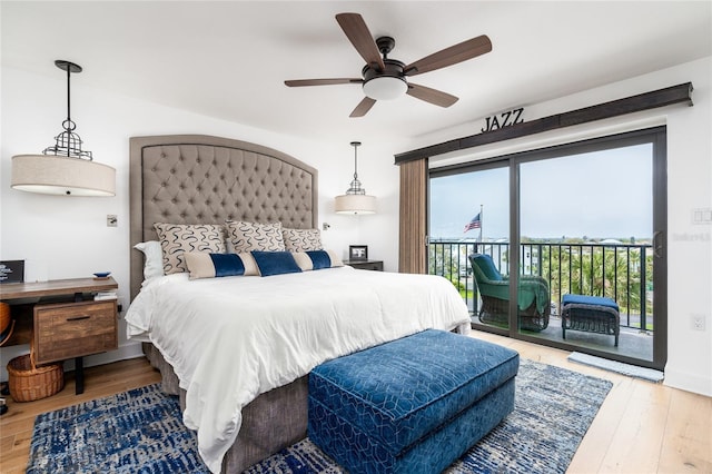 bedroom featuring access to outside, hardwood / wood-style flooring, and ceiling fan