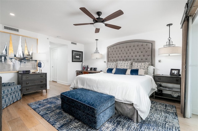 bedroom featuring light wood-type flooring and ceiling fan