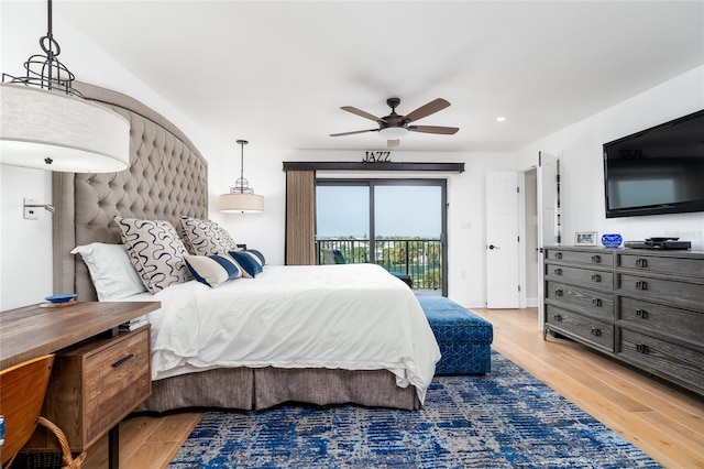 bedroom featuring hardwood / wood-style floors, ceiling fan, and access to outside