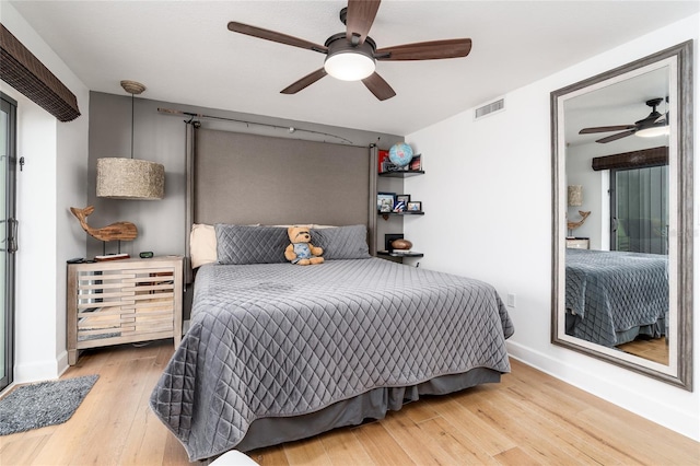 bedroom featuring hardwood / wood-style flooring and ceiling fan