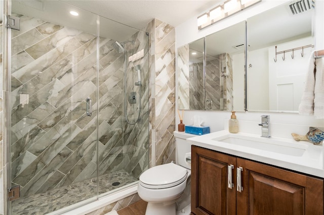 bathroom with vanity, toilet, and an enclosed shower