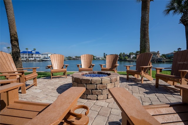 view of patio featuring a water view and a fire pit