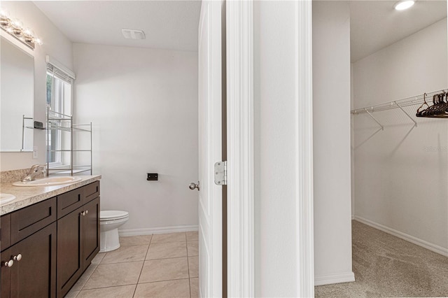 bathroom with vanity, toilet, and tile patterned flooring