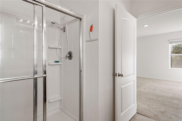 bathroom with a shower with shower door