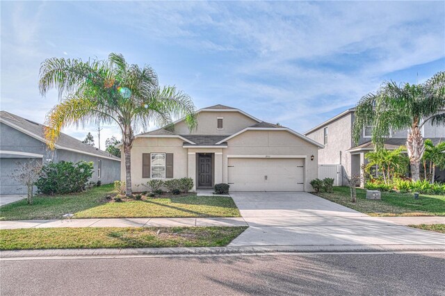 view of front of house with a garage and a front yard