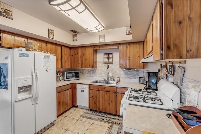 kitchen with decorative backsplash, white appliances, sink, and light tile patterned floors