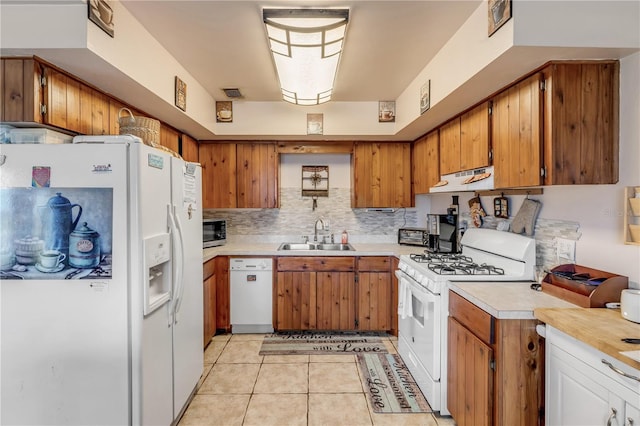 kitchen with white appliances, ventilation hood, sink, light tile patterned floors, and tasteful backsplash