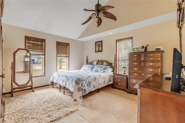 carpeted bedroom featuring multiple windows, ceiling fan, and vaulted ceiling