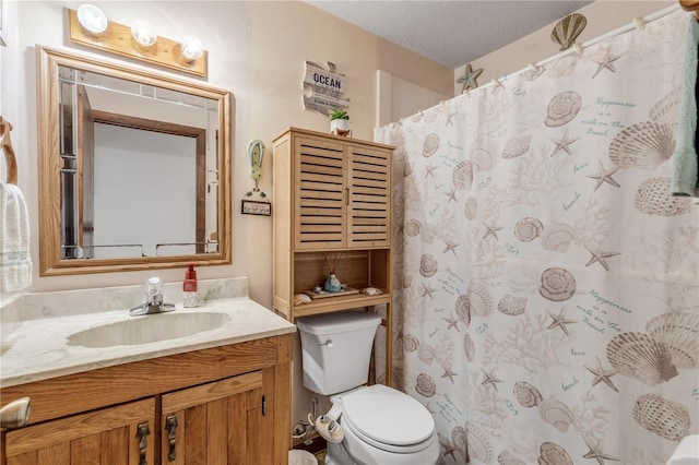 bathroom featuring vanity, a textured ceiling, and toilet