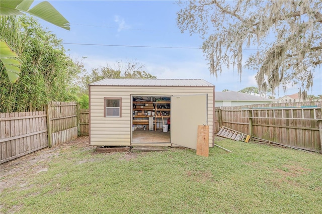 view of outbuilding with a lawn