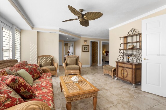 tiled living room featuring ornamental molding and ceiling fan