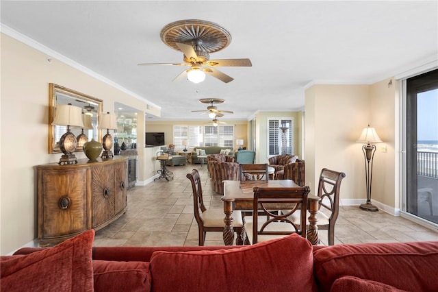 dining space featuring ornamental molding and ceiling fan