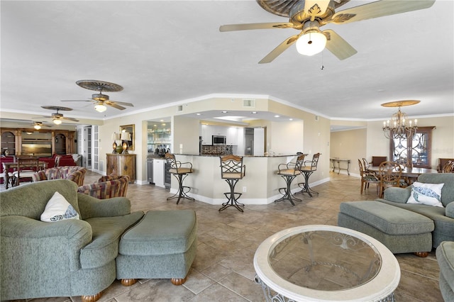 living room with light tile patterned flooring, ornamental molding, and ceiling fan with notable chandelier