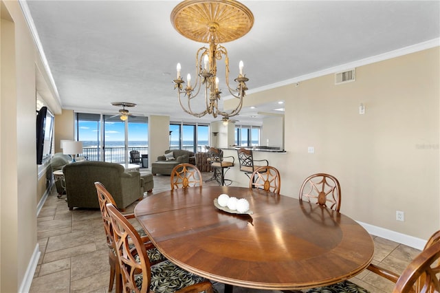 dining area featuring a notable chandelier, ornamental molding, and a wealth of natural light