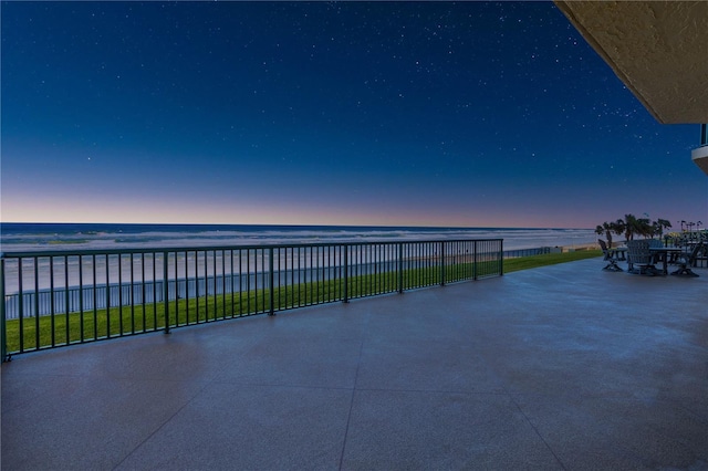 patio terrace at dusk with a water view