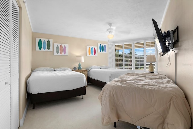 bedroom with light carpet and ceiling fan