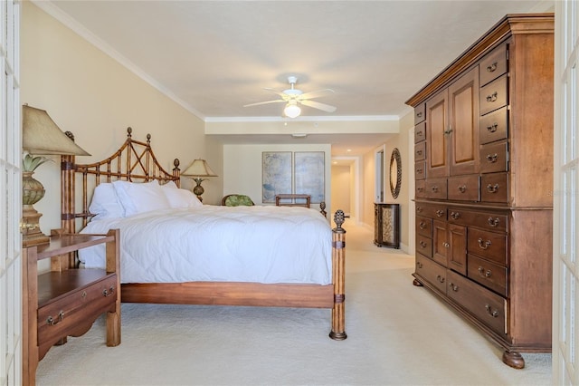 carpeted bedroom featuring ceiling fan and ornamental molding