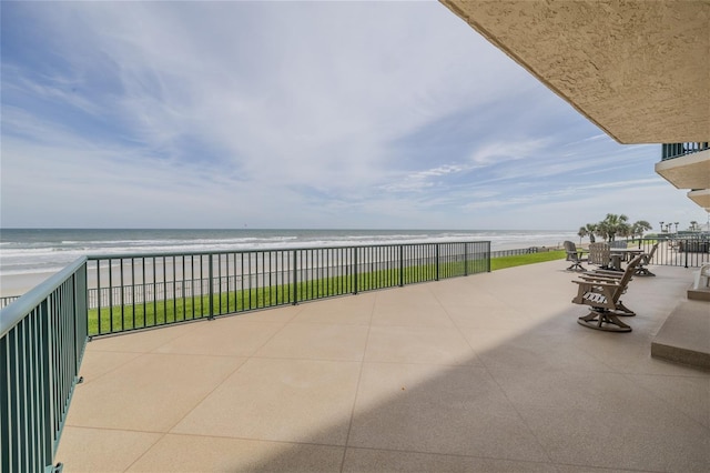 view of patio featuring a water view and a view of the beach