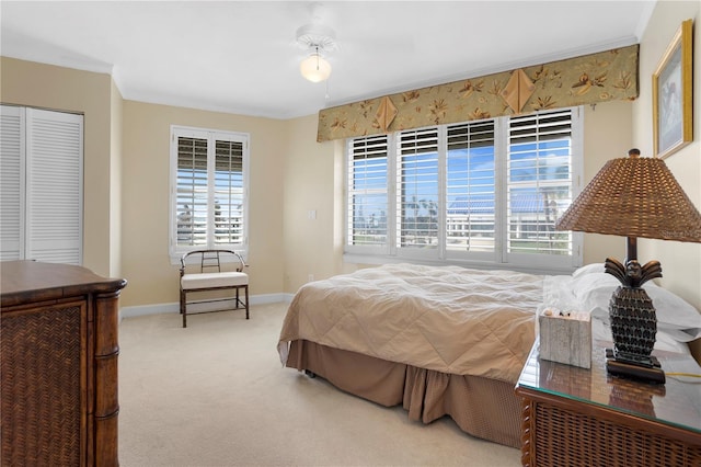 carpeted bedroom featuring ornamental molding and a closet