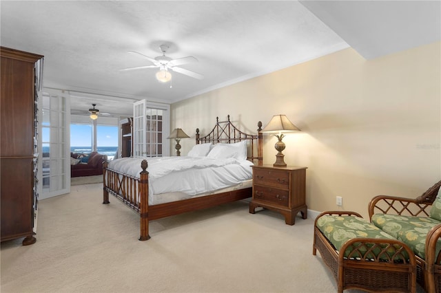 bedroom with crown molding, light colored carpet, and ceiling fan