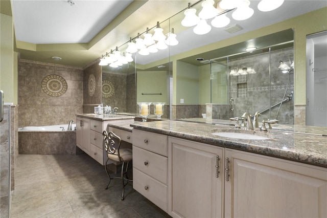 bathroom with tile patterned flooring, plus walk in shower, tile walls, and vanity