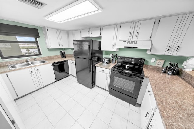 kitchen featuring black appliances, white cabinetry, sink, and light tile patterned floors