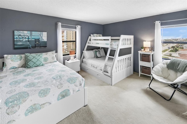 carpeted bedroom featuring a textured ceiling