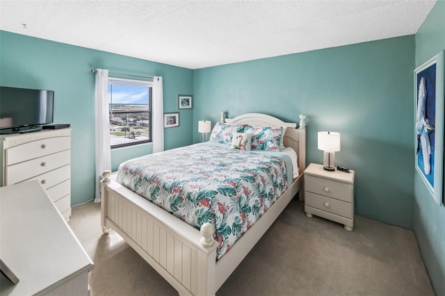 bedroom featuring carpet floors and a textured ceiling