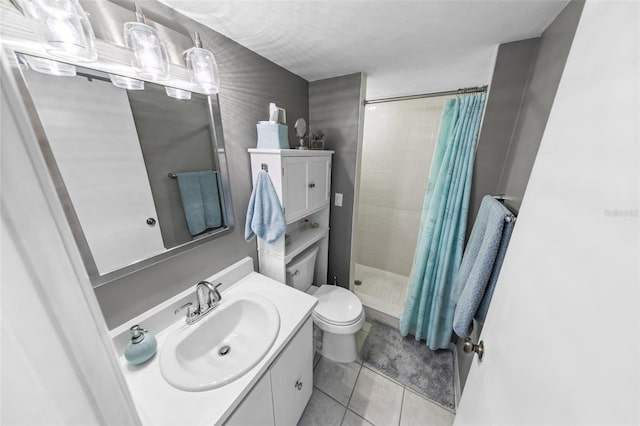 bathroom featuring tile patterned flooring, vanity, toilet, and curtained shower