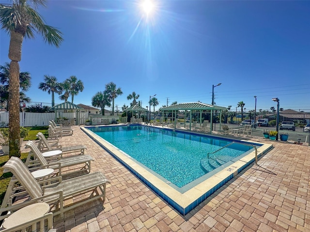 view of swimming pool with a gazebo and a patio area