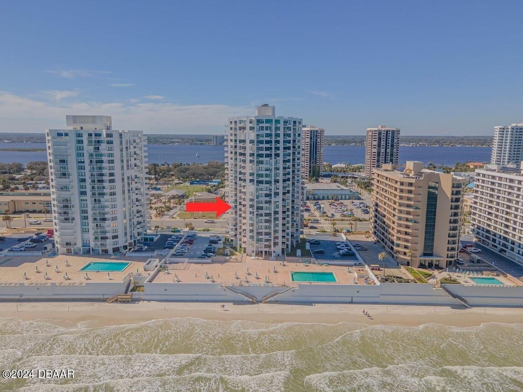 birds eye view of property with a view of the beach and a water view