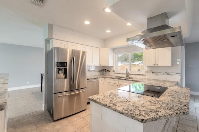 kitchen with sink, light stone counters, white cabinetry, island exhaust hood, and stainless steel appliances