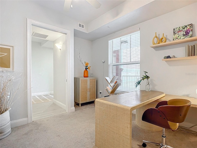 carpeted office with ceiling fan