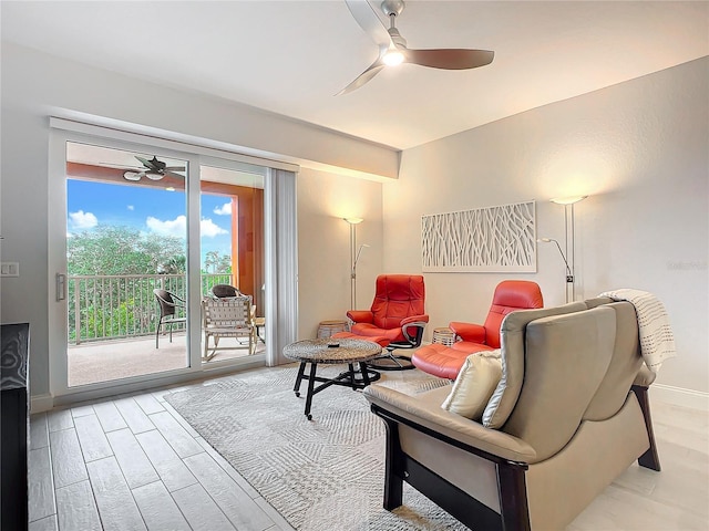 living room with ceiling fan and light hardwood / wood-style floors