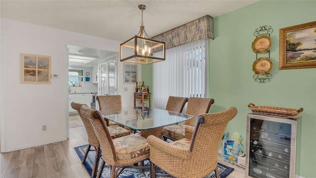 4411 Sea Mist Ct Unit 275, New Smyrna Beach, FL 32169 - dining space with beverage cooler, a chandelier, and light wood-style floors