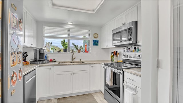 4411 Sea Mist Ct Unit 275, New Smyrna Beach, FL 32169 - kitchen with appliances with stainless steel finishes, white cabinetry, and backsplash