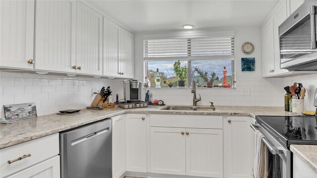 4411 Sea Mist Ct Unit 275, New Smyrna Beach, FL 32169 - kitchen featuring stainless steel appliances and white cabinets