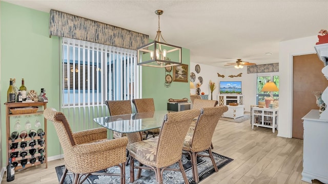 4411 Sea Mist Ct Unit 275, New Smyrna Beach, FL 32169 - dining area with light wood-type flooring, a chandelier, and ceiling fan