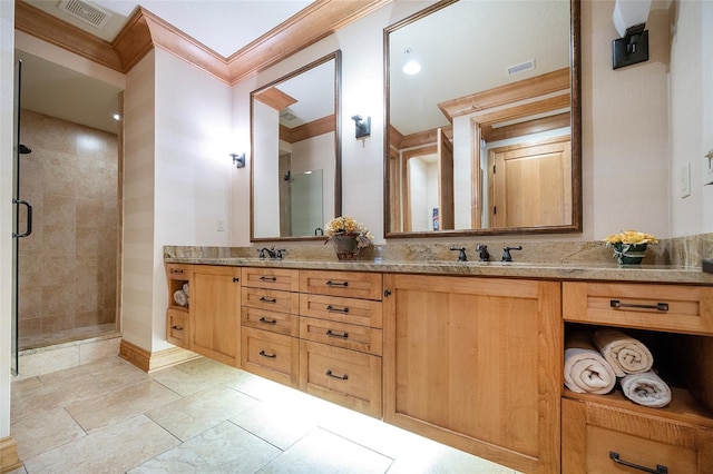 bathroom with crown molding, vanity, and an enclosed shower