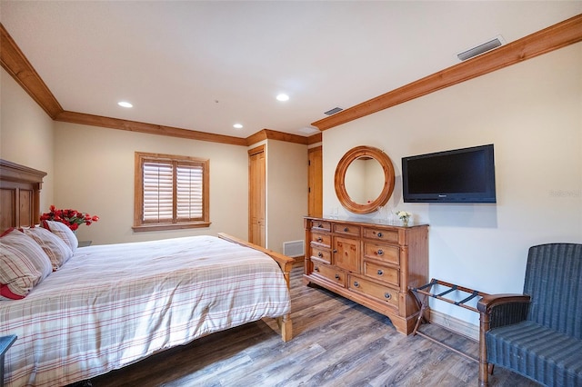 bedroom featuring hardwood / wood-style flooring and ornamental molding